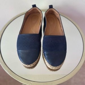 Clark’s flats. Breathable material in the front.